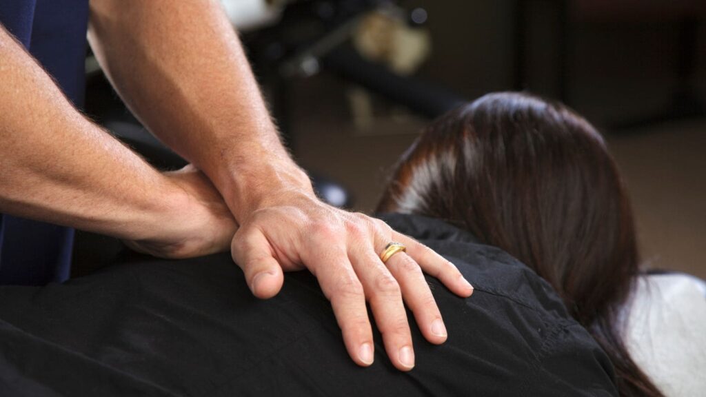 A chiropractor manipulating a patient